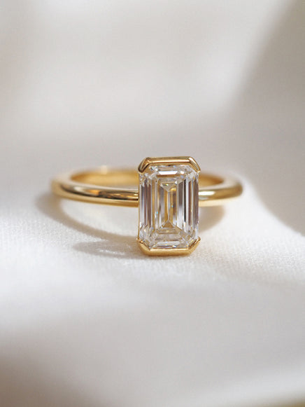 Half Bezel Emerald Solitaire